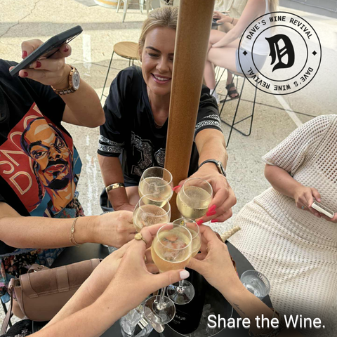 Friends saying "cheers" to a great afternoon at Dave's Wine Revival, Fortitude Valley, connecting over great wine in lovely surrounds.